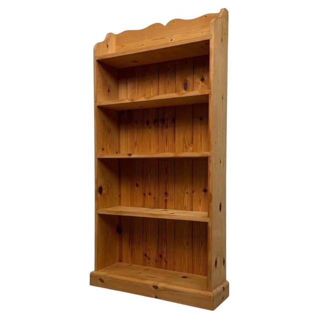 A handsome and well-crafted vintage 20th-century open bookcase, constructed in beautifully grained pine and distinguished...
