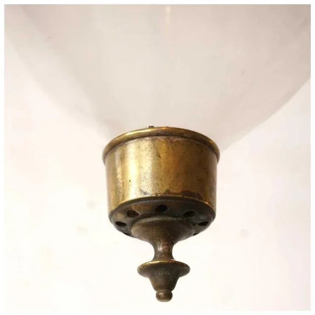 DETAILS This elongated, antique English pendant hall light features a clear blown glass bell with brass terminal, all...