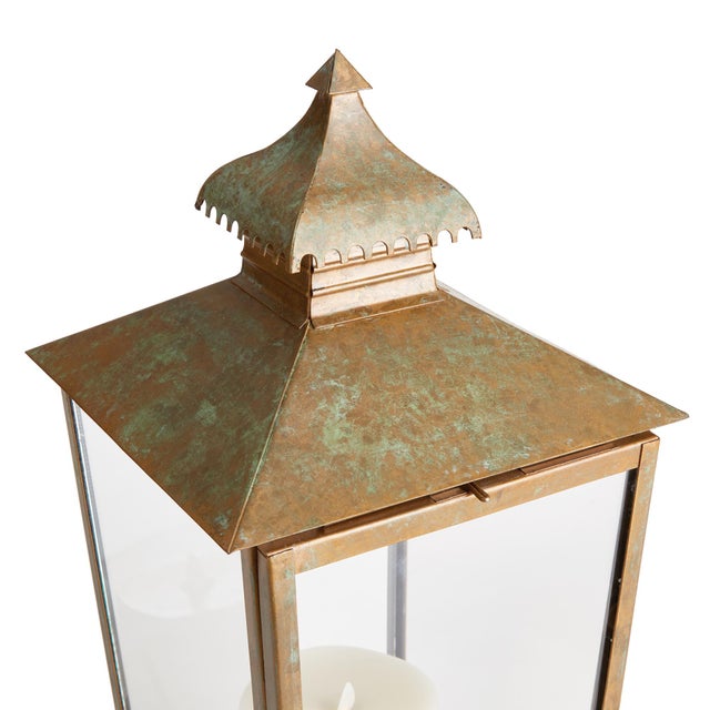 Simple in design and topped with a curved pagoda and notched edge, this lantern is full of character. The warm patina...