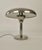 A Bauhaus desk lamp in chrome plated metal. Looking at the lamp from the side you will discover a sculptural form, with...