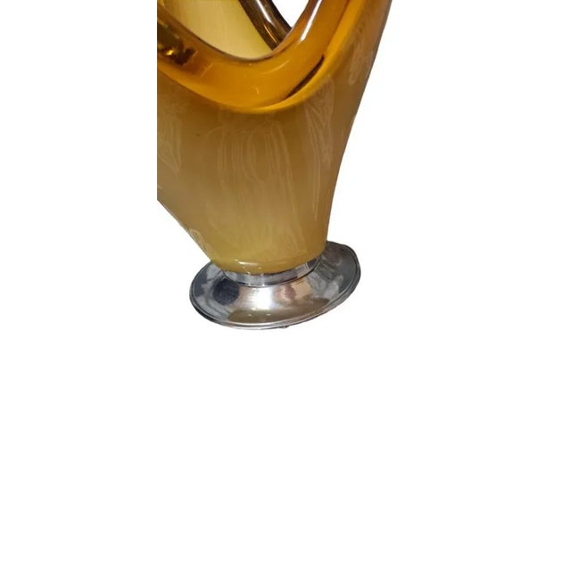 Beautiful Murano glass centerpiece in vintage honey color, with chrome metal base, in perfect condition.