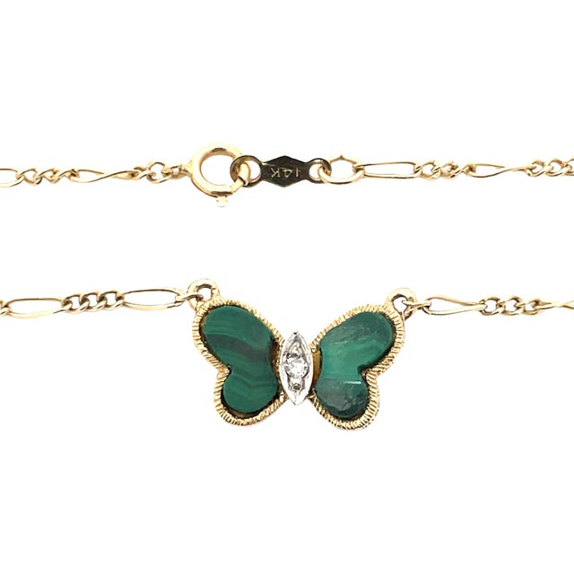 14K yellow gold butterfly pendant necklace by Hammerman Brothers featuring vibrant green malachite wings. The center is...