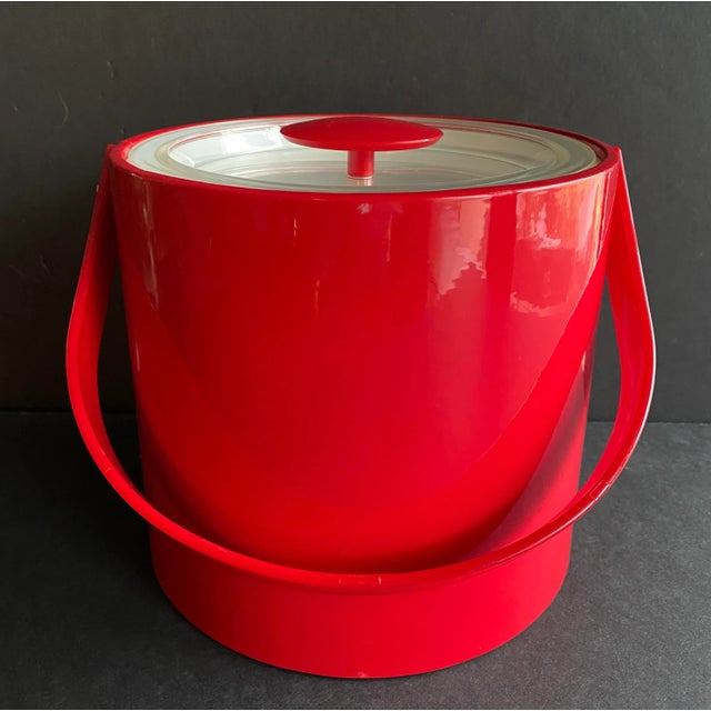 Original Georges Briard shiny vinyl ice bucket in cherry red. This iconic MCM item features a red plastic handle,...