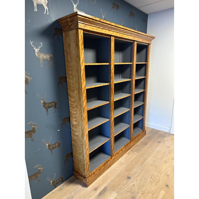 A beautiful, large antique open bookcase made of satinwood. Features adjustable shelves. The interior of the bookcase has...