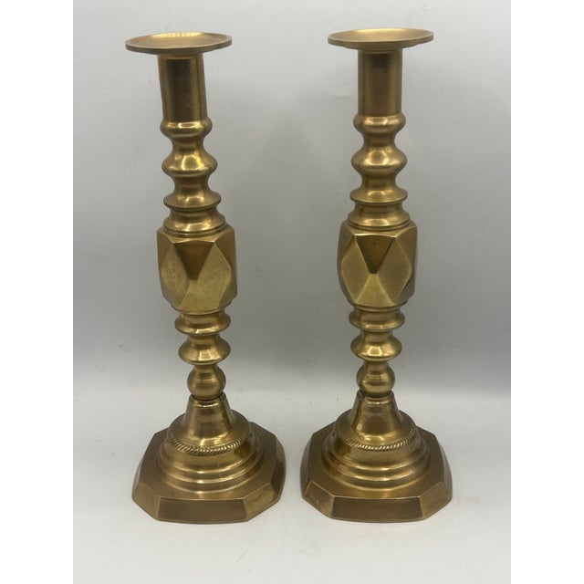 A pair of English "King of Diamond" solid brass candlesticks, produced in 1897 to commemorate Queen Victoria's Diamond...