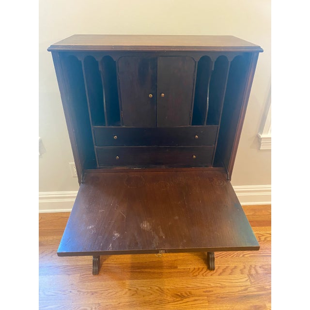 Vintage wood tall secretary having pretty flat front with carved wood decoration and urn shape in the center. Lovely grain...