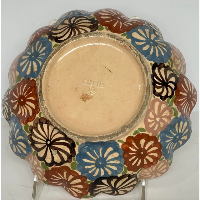 Vintage scalloped bowl with center of bowl showing three flowers with leaves. The outside of the bowl is complelely...