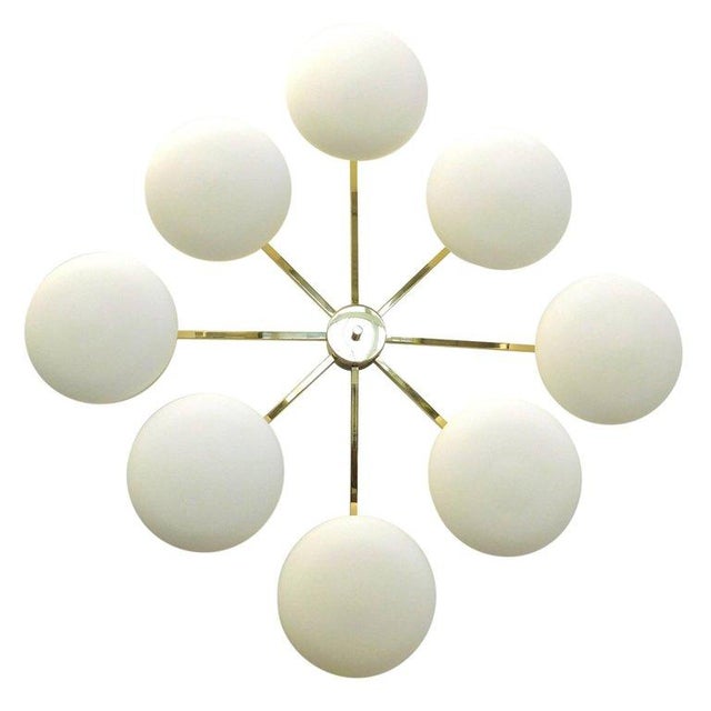 Italian flush mount with eight matte white Murano glass shades mounted on solid brass frame in lacquered polished brass...