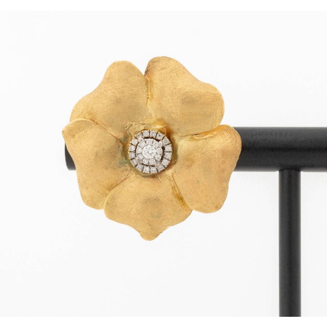Pair of Flower Form 14K Yellow Gold and Diamond Earrings, featuring fifty two prong set round brilliant cut diamonds...