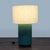 This CB2 table lamp features a simple white drum shade and a stylish green gradient ceramic base. It offers a clean,...
