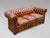 A stunning late 19th-century Victorian three-seater brown leather Chesterfield sofa with three loose feather filled...