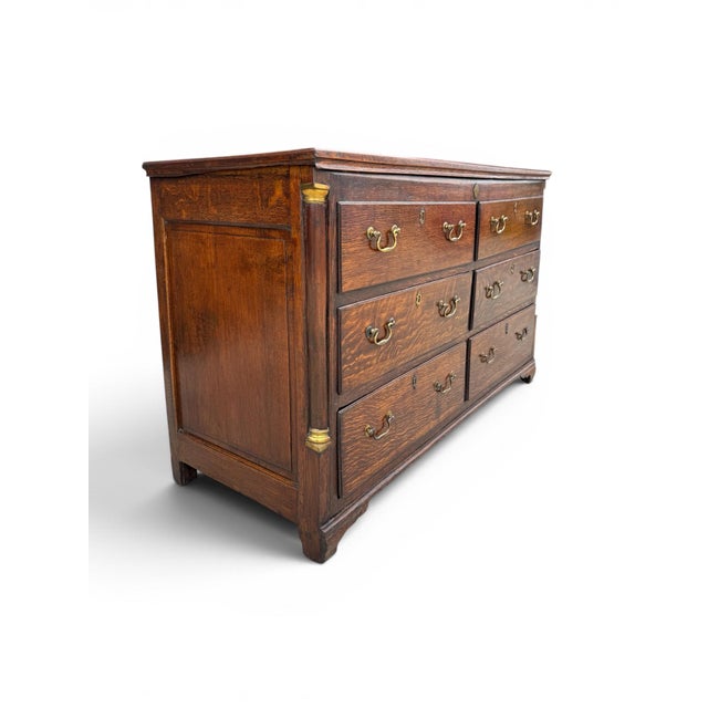 A handsome English George III oak dresser dating to the late 18th or early 19th century. The substantial case features six...
