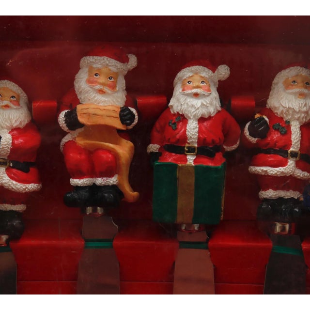 A set of four spreader knives topped with Santa’s, made for the May Department Stores Company. Un-opened and in the...