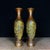 Sold as a pair, these exquisite vases feature a classic baluster silhouette with a flared rim and a fluted base. The...