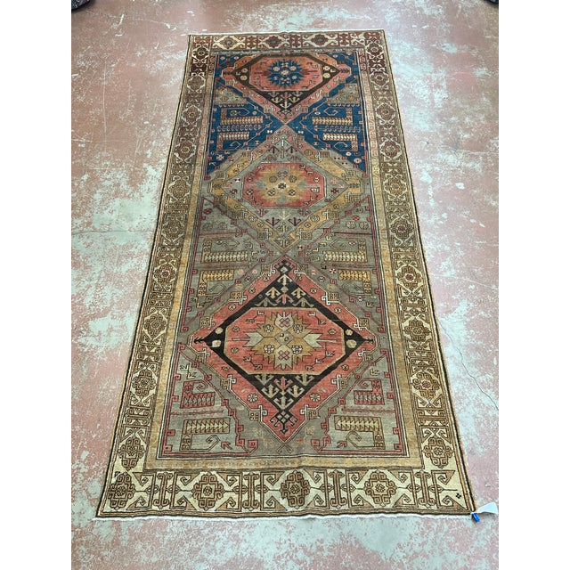 Antique Turkish runner, hand knotted in Turkey from 100% wool. Measuring 5’3” x 11’10”, this long and narrow rug features...