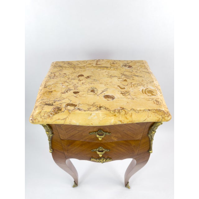 Elegant 19th century French Empire gueridon in mahogany, featuring a substantial marble top with warm ochre veining and...