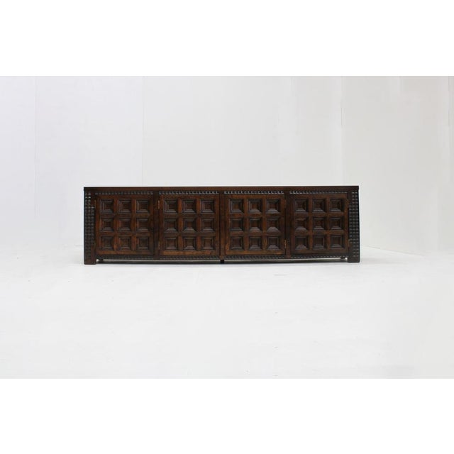 Spanish Brutalist Sideboard in solid wood from the 1960s. Beautifully designed with graphical squared wood carvings on the...