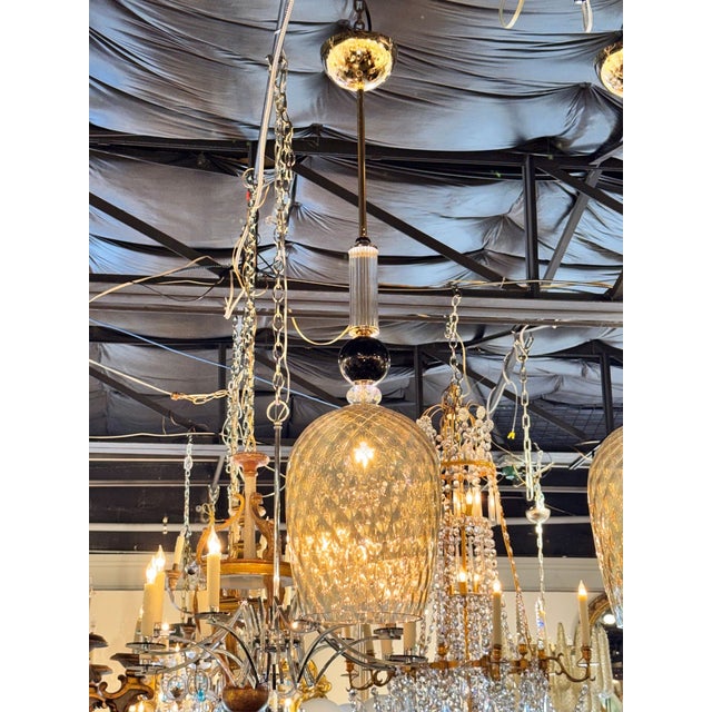 The product is a pair of Murano glass pendants in gold and black, designed to add a touch of elegance to any room. These...