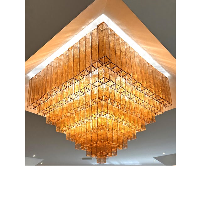 Elegant luxury flush mount made in amber-Rosè Murano glass “squared” elements. “Squared ” are blown inside a wooden mold,...