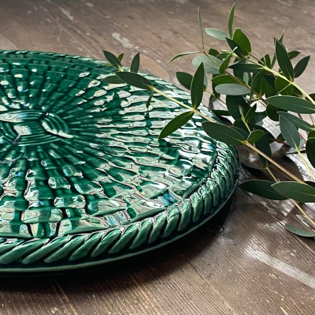 Vintage ceramic trivet and bottle coaster with a woven basket design. Both practical and decorative, it adds a touch of...