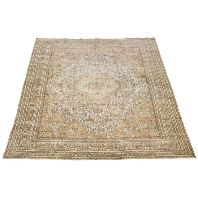 This exquisite hand-knotted Agra wool rug features an ivory field accented by tan motifs in a timeless medallion floral...