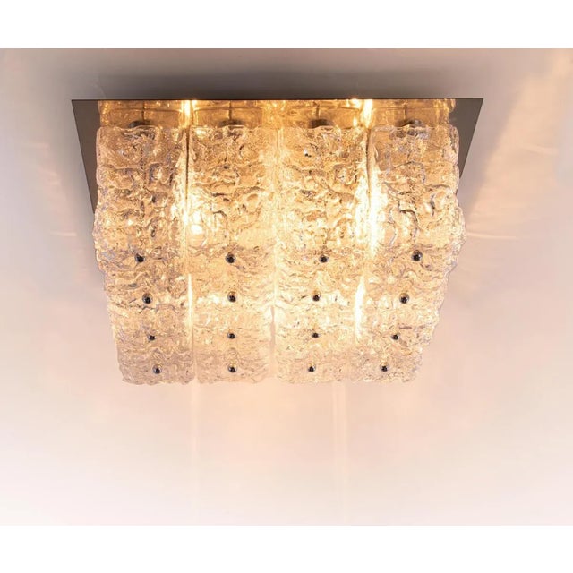 Elegant large cubist flush mount ceiling lamp with sixteen large glass blocks with a textured structure fixed on a golden...