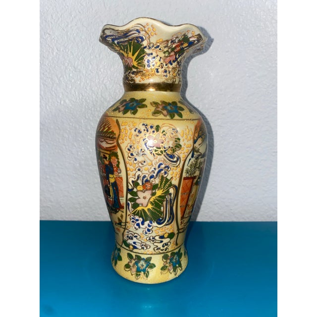 Hand painted Moriage/Satsuma style vase with fluted top. Vibrant colors including blue, turquoise, pink, orange, green,...