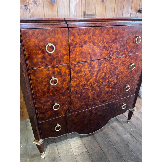 A strikingly handsome tall chest of drawers in a brown tortoise shell lacquer finish by John Widdicomb Furniture. This...