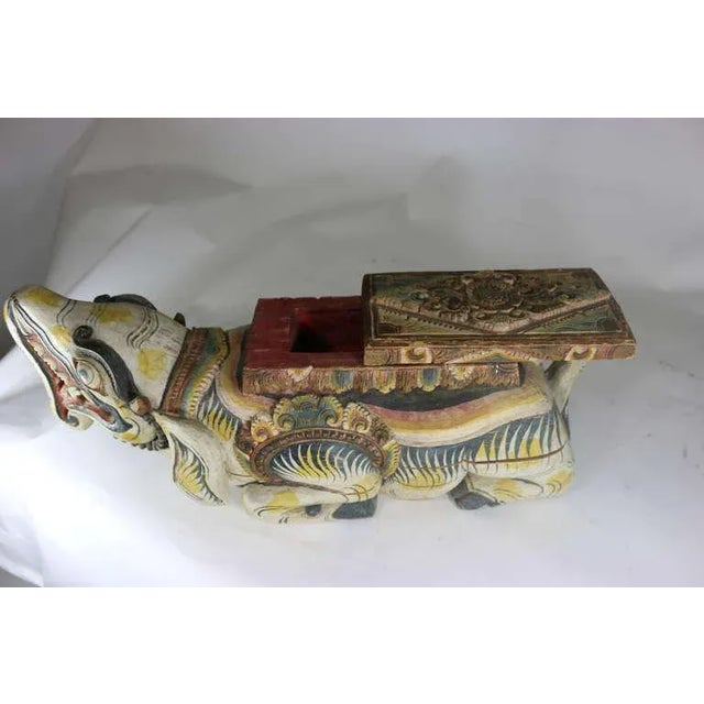 A rare very decorative Indonesian poly chrome highly carved in relief wood box--the top portion slides open to reveal the...