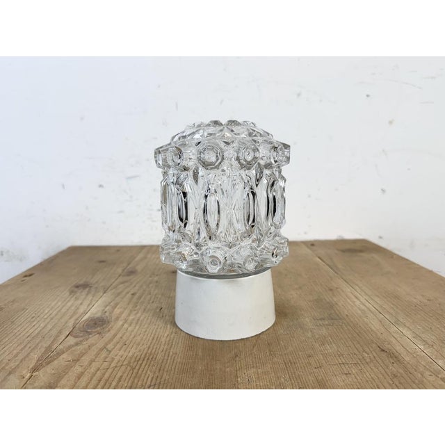 Vintage industrial ceiling or wall light made in former Czechoslivakia during the 1970s. It features a white porcelain...