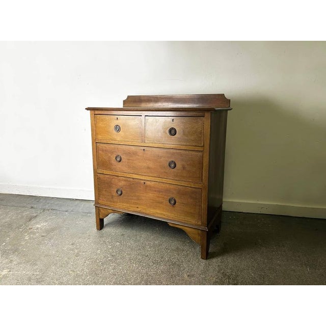 An attractive antique Edwardian mahogany chest of drawers, dating from the early 20th century, circa 1900–1915. The chest...