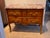 18th century French commode with a molded rouge marble top over two drawers with banded inlay and gilt bronze foliate...