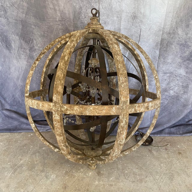 Add rustic character to your home with this large wood-and-metal orb chandelier, believed to be from the Yosemite Home...