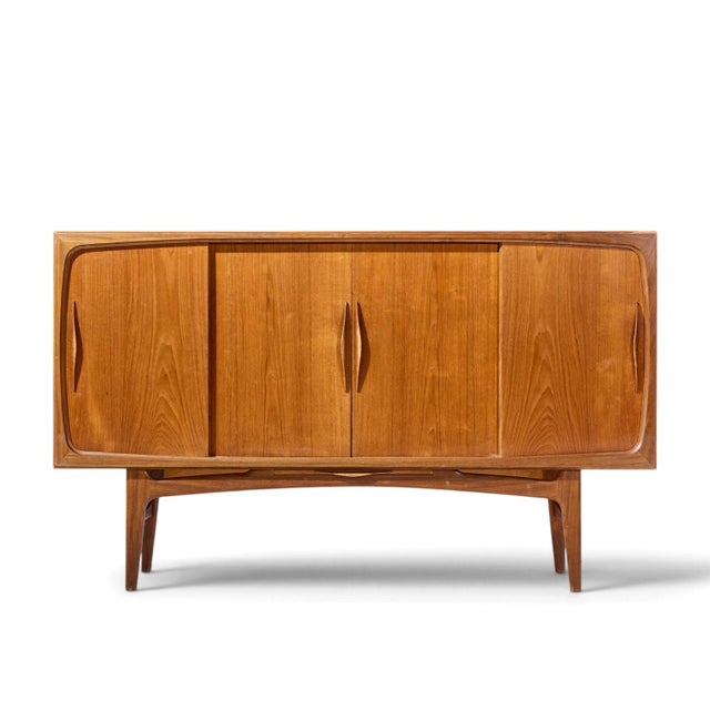 Kurt Østervig Style Mid Century Danish Sculptural Teak High Credenza This credenza measures: 74.75 wide x 17.75 deep x 45...