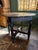Antique English Jacobean-style oak drop-leaf table featuring a unique shaped top, turned legs, and a distinctive nailhead...