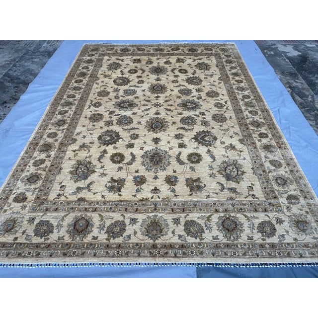 This elegant hand-knotted wool area rug showcases a sophisticated Oushak design with a timeless Chobi finish. The large...