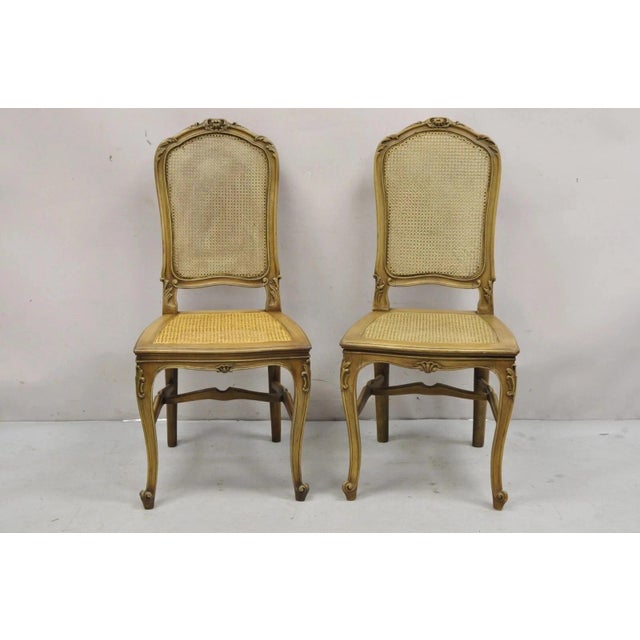 Antique French Provincial Louis XV Style Carved Walnut Cane Dining Side Chairs - a Pair. Item features cane back and seat,...