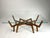 This sculptural mid-century Italian coffee table evokes the form of a spider, with its solid wood base opening into...