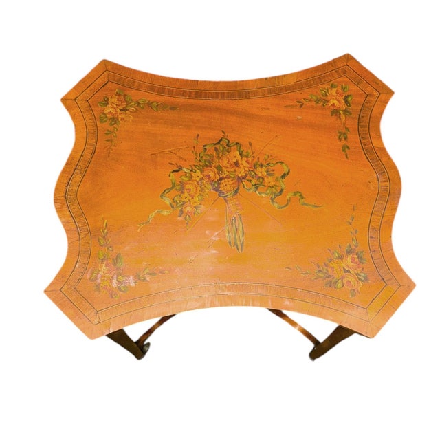 An elegant 19th-century English Adam-style side table, finely crafted in satinwood and maple and distinguished by its...
