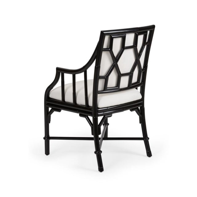 Complete your dining table with our ella armchair. Crafted of black rattan, this chair comes with an off white muslin...