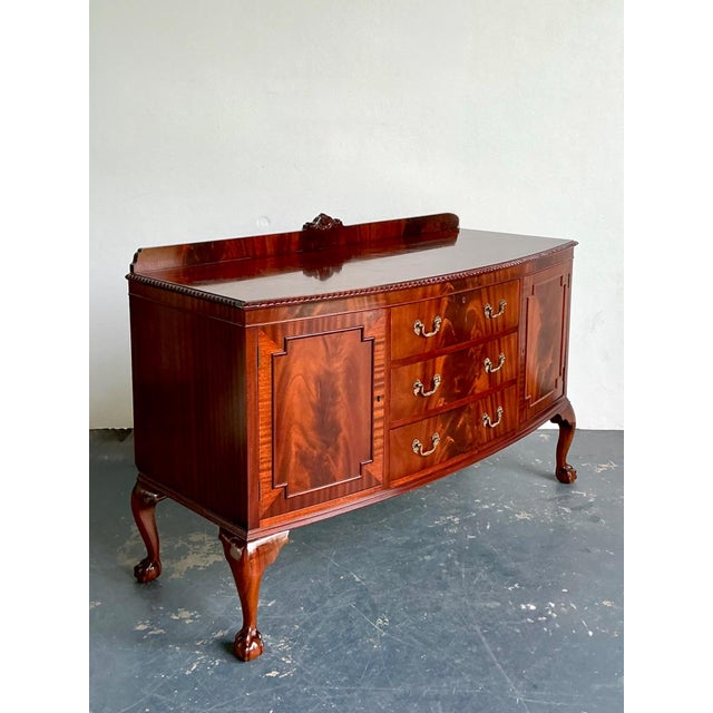 This vintage Chippendale sideboard is a refined expression of classical 18th-century design, masterfully executed in...