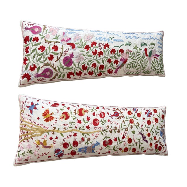 This beautiful 18'' x 54'' hand-embroidered Suzani pillow cover set was made from authentic Uzbek cotton fabric. The...