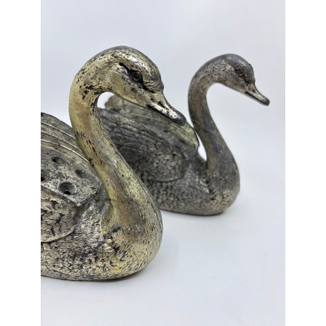 Beautiful pair of antique flower frogs ( flower holders) that are swan shaped. The swans are elegant and will look amazing...