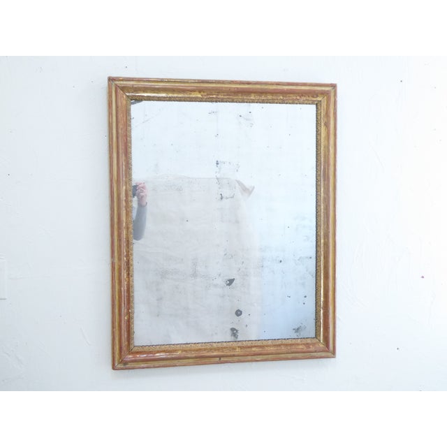 This 19th Century French mirror with parquetry back and original glass mirror, has traces of gilding and the original...