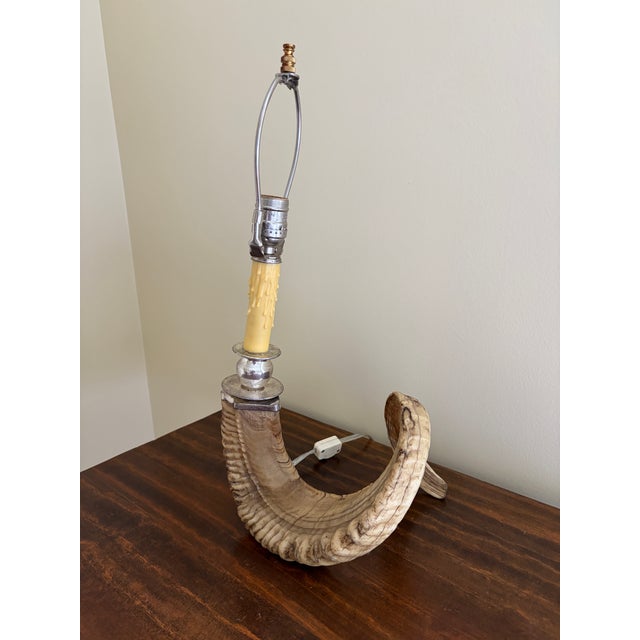 A striking vintage table lamp crafted from a natural ram’s horn, offering a sculptural and textural presence that...