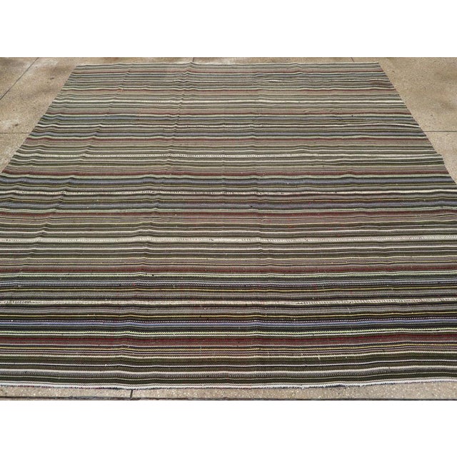 A vintage Turkish flatweave Kilim small room size carpet in square format handmade during the mid-20th century. Measures:...