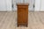 An Italian walnut bedside table from the 19th century with single drawer over single door and carved reeded motifs. This...