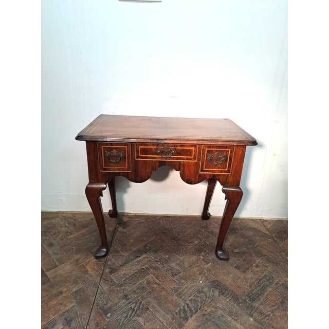 Hutton-Clarke antiques is pleased to offer an early 18th Century Walnut Lowboy with strinhing.Standing on finely shaped...