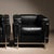An iconic duo in design history: this pair of lc2 armchairs impresses with the architectural precision of the chromed...