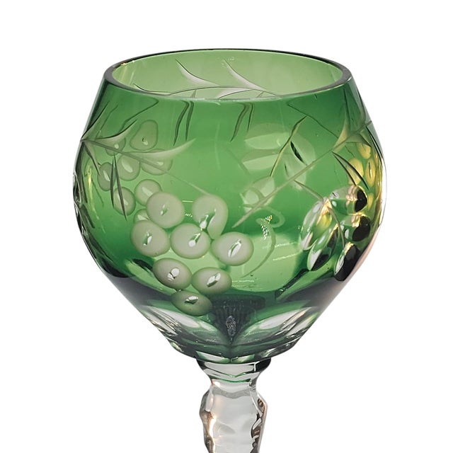 There is a certain hush in crystal like this, where light clings to green and clear in delicate union. The grapes, etched...